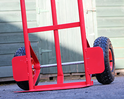 Photo of the pneumatic wheels on a red Hand Truck